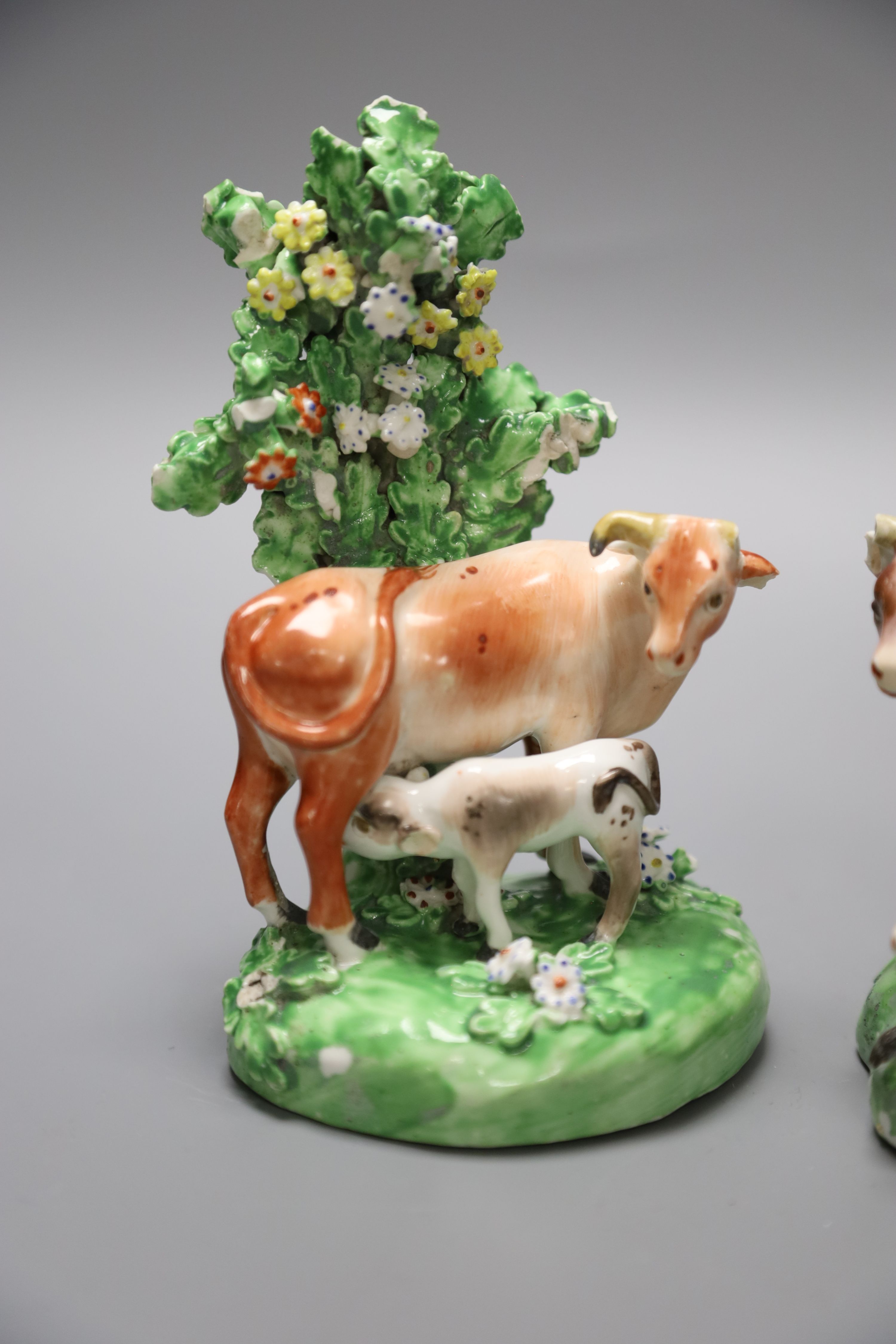 A 19th century Derby pair of cow and calf groups, height 15cm
